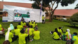 Young people take part in an SRHR counselling session delivered by the Assistant DHO for Maternal and Child Health, Wakiso District, during a PHIC Adolescent & Youth Health Camp.