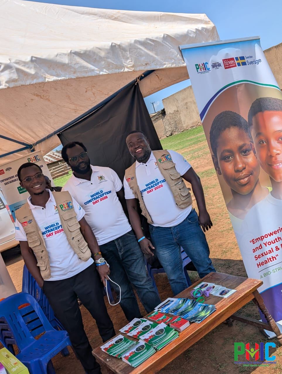 PHIC staff at the PHIC exhibition stand with the Empowering Adolescents and Youth banner