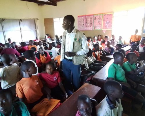 PHIC staff conducting IEC session on 30th April 2024 
At Kisimbiri church of Uganda primary school